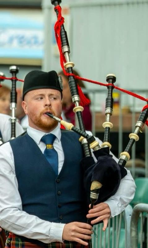 Andrew McCrindle, Pipe Sergeant, playing bagpipes in band uniform