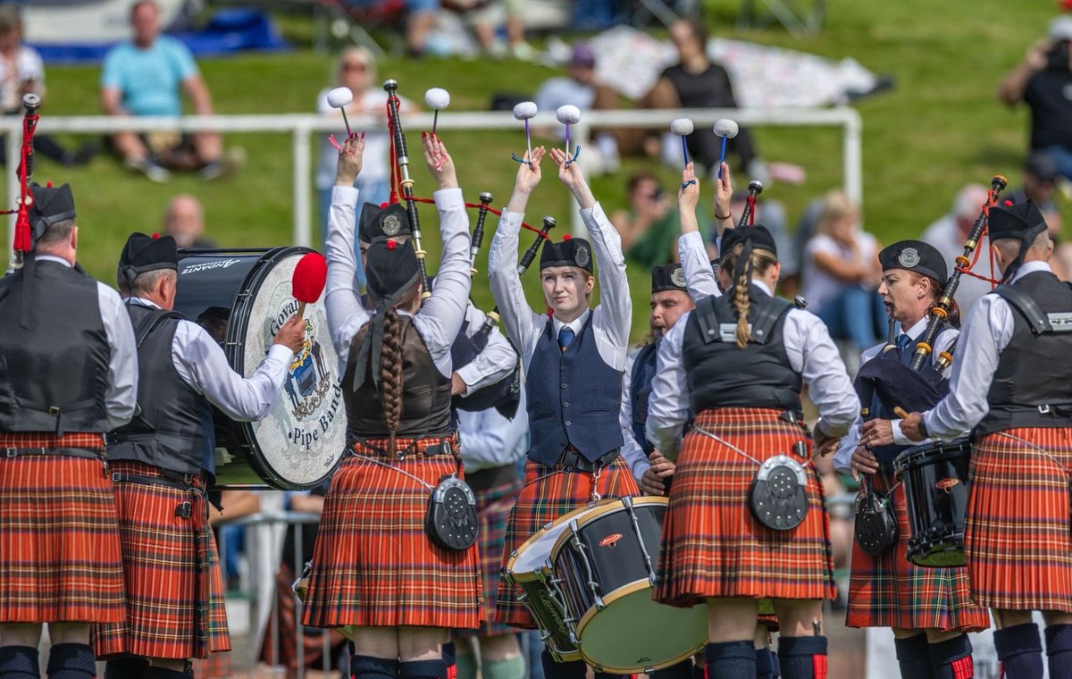 Drummers with mallets raised mid-performance